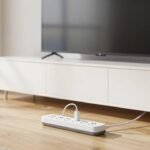 Surge protector power strip on hardwood floor in a modern American living room