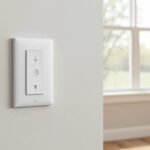 White smart light switch on a light drywall in a modern American living room with daylight from a double-hung window